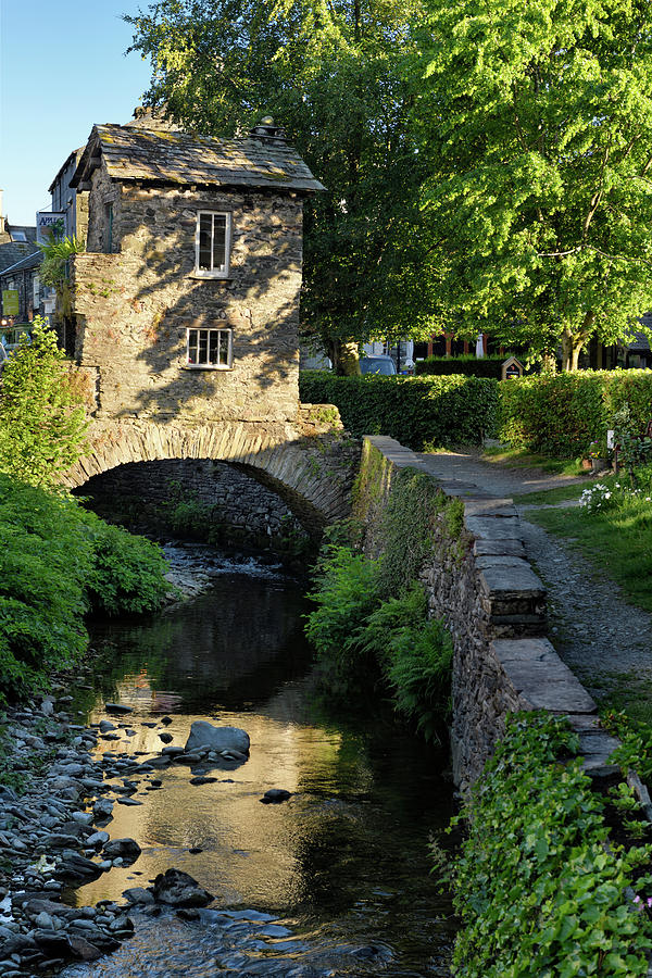 Bridge House on bridge over Stock Beck river with reflection of  Photograph by Reimar Gaertner