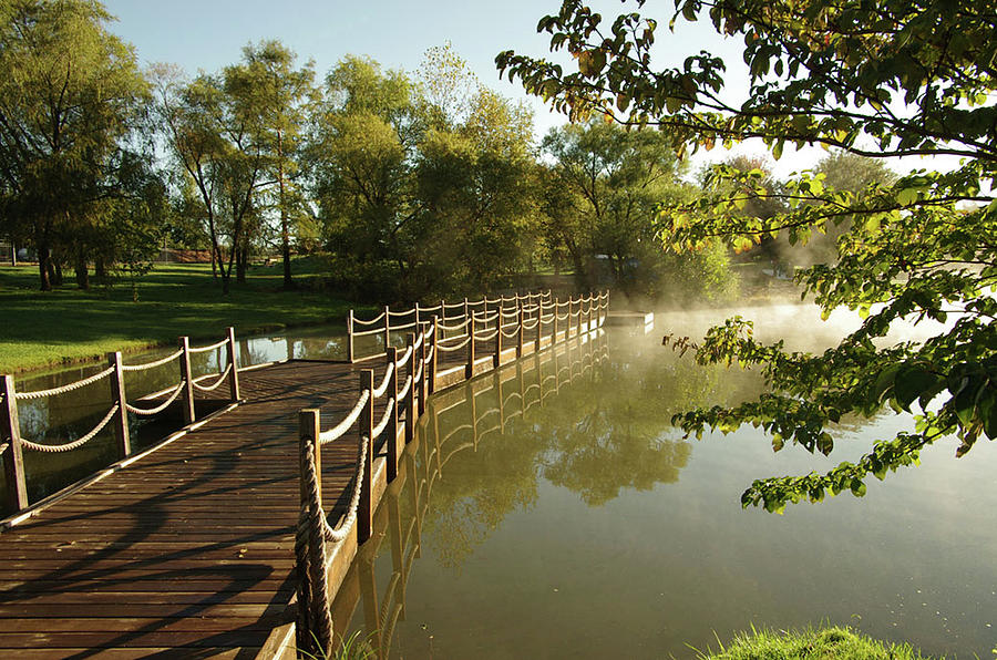 Bridge over a pond at sunrise Photograph by Jim Mathis
