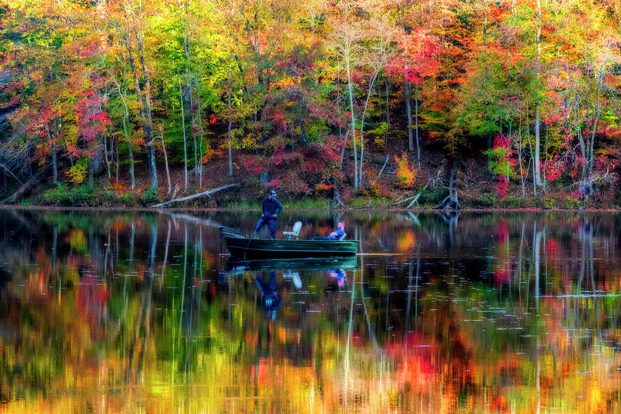 Brilliant colors surrounding fishing boat in the on a lake Photograph by Dan Friend
