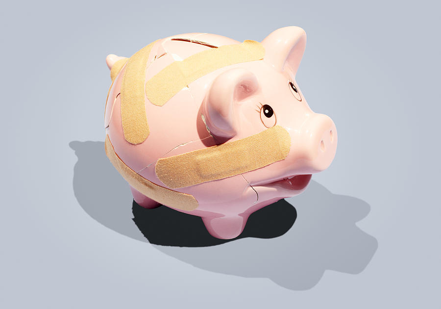 Broken piggy bank with plasters. Photograph by Tim Robberts