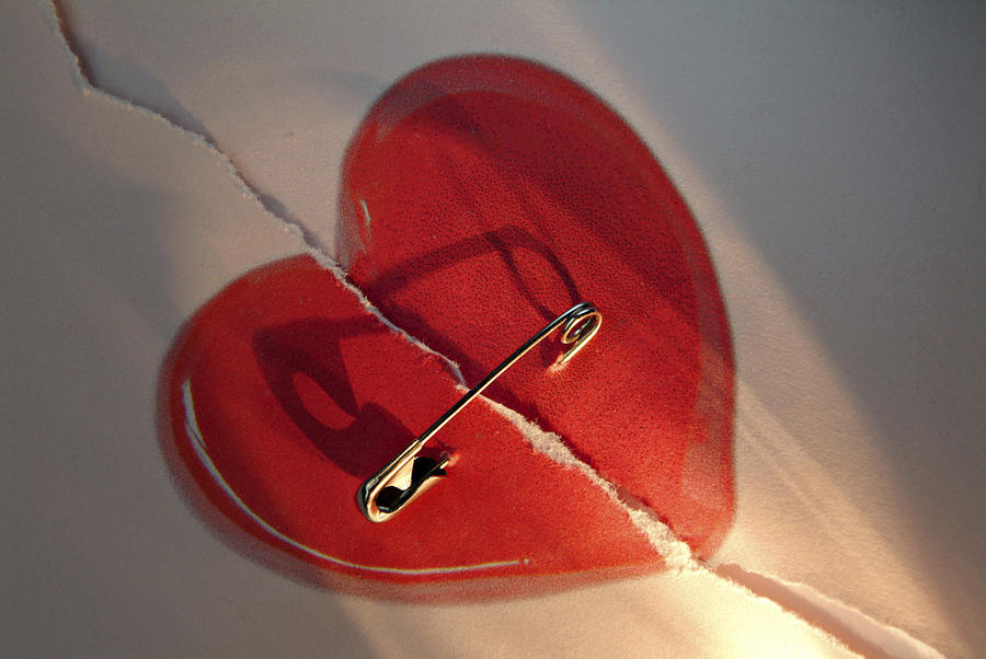 Broken red love heart repaired with a safety-pin Photograph by Harald Theissen