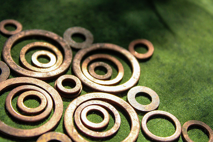 Bronze Washers on Green Fabric Photograph by Windy Craig