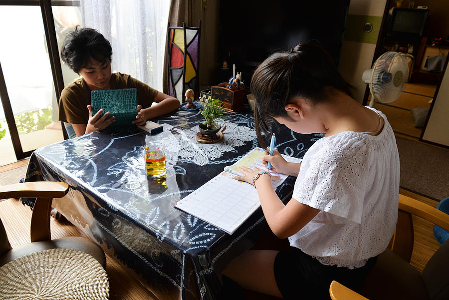 Brother and sister studying at home Photograph by Akiko Aoki