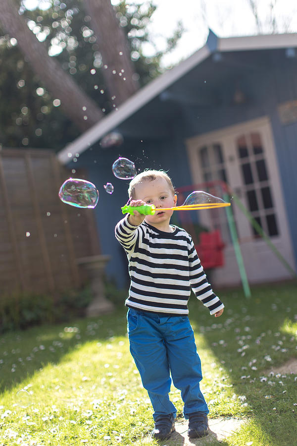 Bubble fun in the garden Photograph by s0ulsurfing - Jason Swain