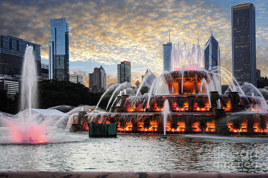 Buckingham fountain water display in front of the Chicago Skyline right at the sunset hour. Photograph by Gunther Allen