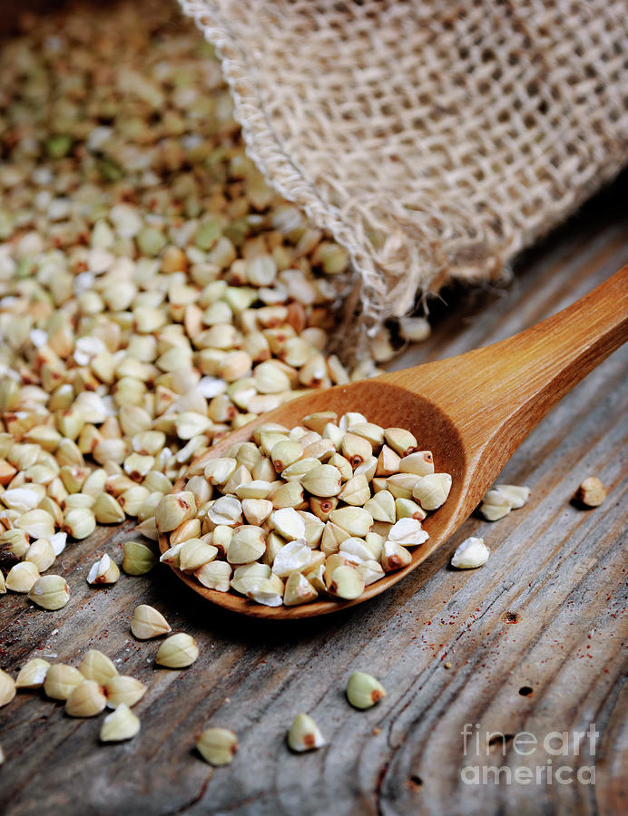 Buckwheat in wooden spoon closeup Photograph by Jelena Jovanovic