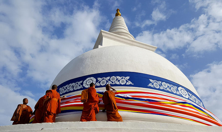 Buddhist  monks adorning the Thuparama dagoba with the Buddhist flag, Sri Lanka Photograph by Frans Sellies