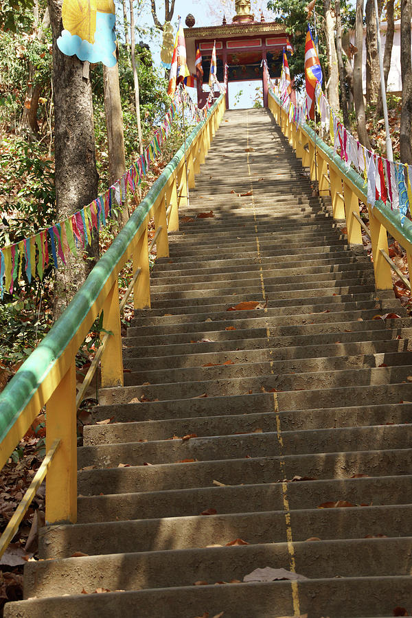 Buddhist prayer flags line the stairway at  Sambuk  Photograph by Steve Estvanik