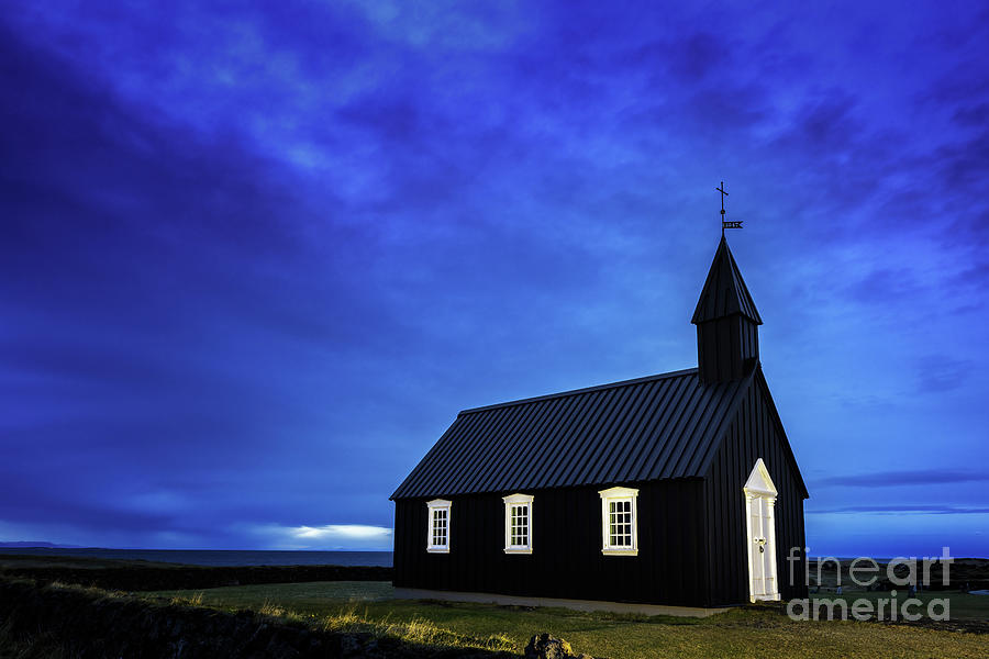 Budir Black Church, Snaefellsnes peninsula, Iceland. Blue hour shot of the illuminated wooden church, just before daybreak. Photograph by Jane Rix