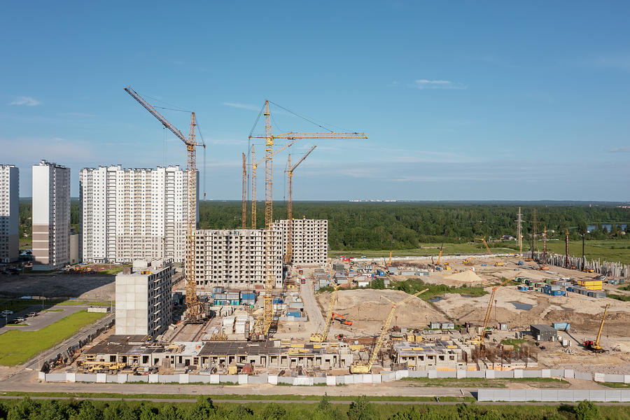 Building crane and buildings under construction Photograph by Mikhail Kokhanchikov