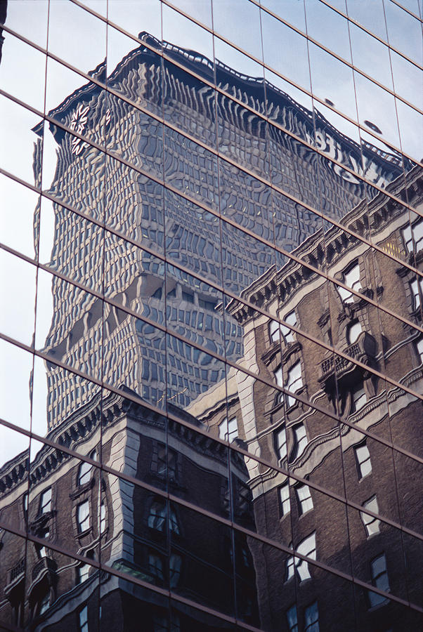 Buildings And A Skyscraper Are Reflected In The Glass Windows Of A Large Building Photograph by Heinz Hubler
