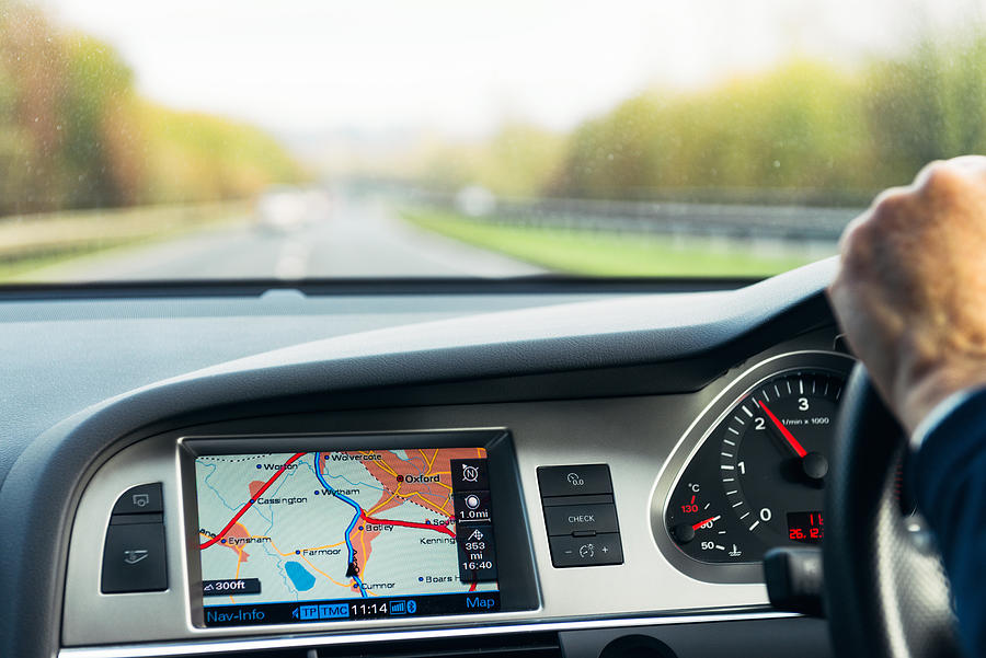 Built-in Audi satellite navigation in use on UK road Photograph by Georgeclerk