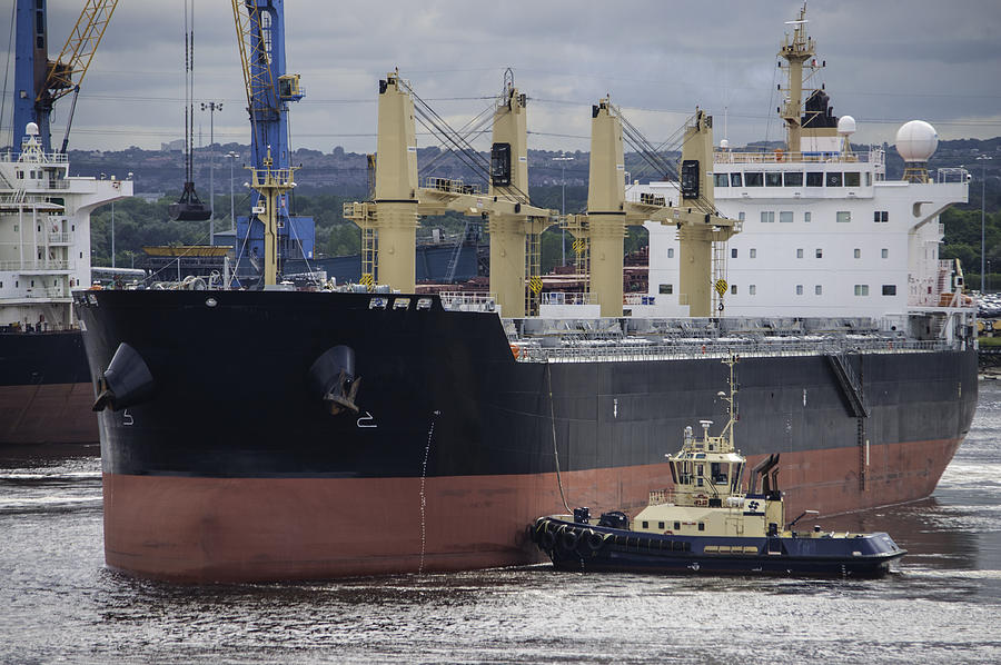 Bulk carrier ship, manoeuvred into dock by tugboat Photograph by John Lawson, Belhaven