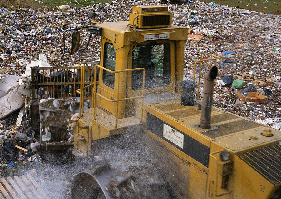 Bulldozer in trash dump Photograph by James Hardy