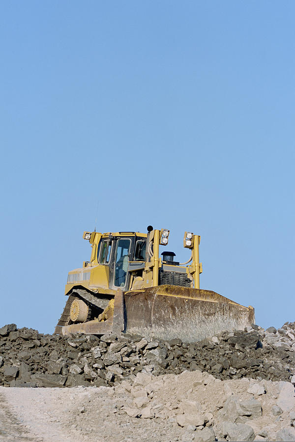 Bulldozer moving dirt at road building site Photograph by Comstock Images