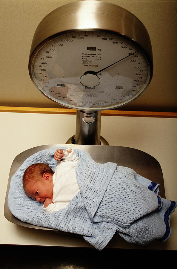Bundled Newborn Baby On Weight Scale Photograph by Terje Rakke