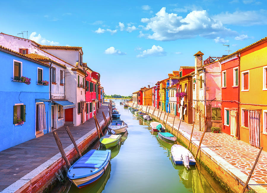 Burano island canal, colorful houses and boats in the Venice lag ...
