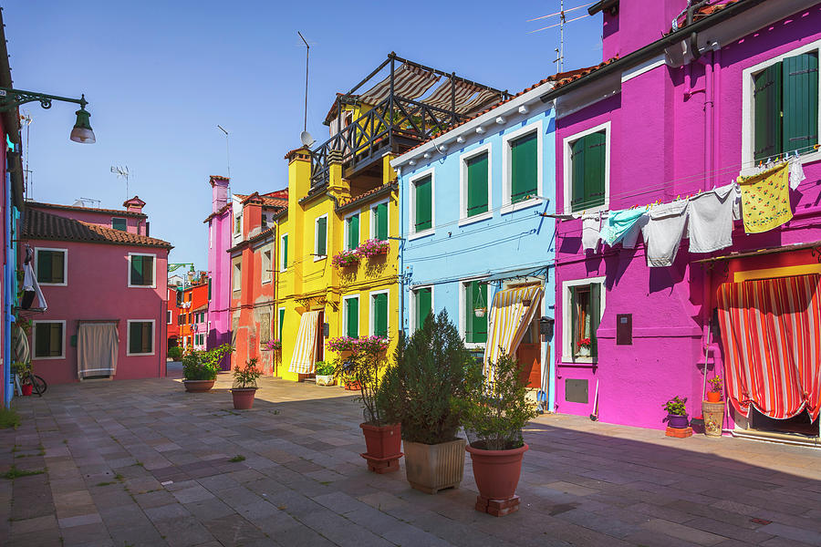 Burano island street, colorful houses in the Venice lagoon Photograph by Stefano Orazzini
