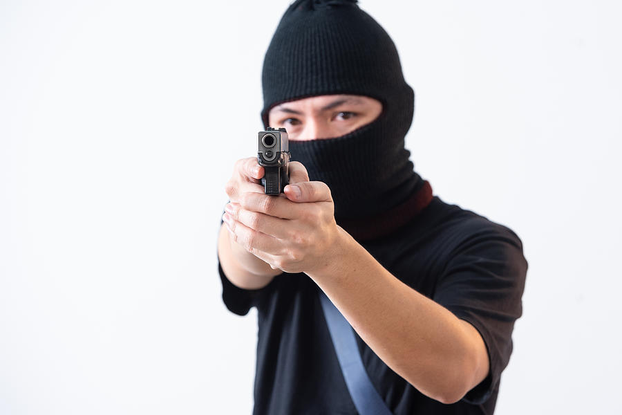 Burglar Or Terrorist In Black Mask Shooting With Gun Isolated On White Background Photograph by Chadchai Ra-ngubpai