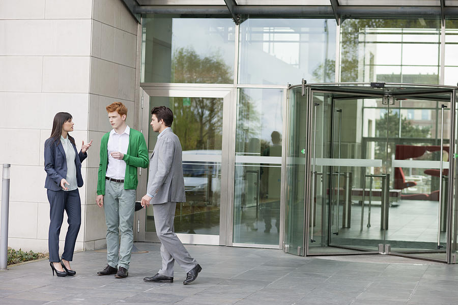 Business executives smoking in front of an office building Photograph by ONOKY - Fabrice LEROUGE