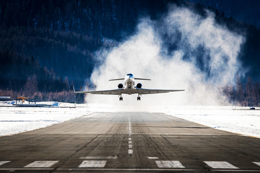 Business Jet departing a snowy airfield Photograph by Jetlinerimages