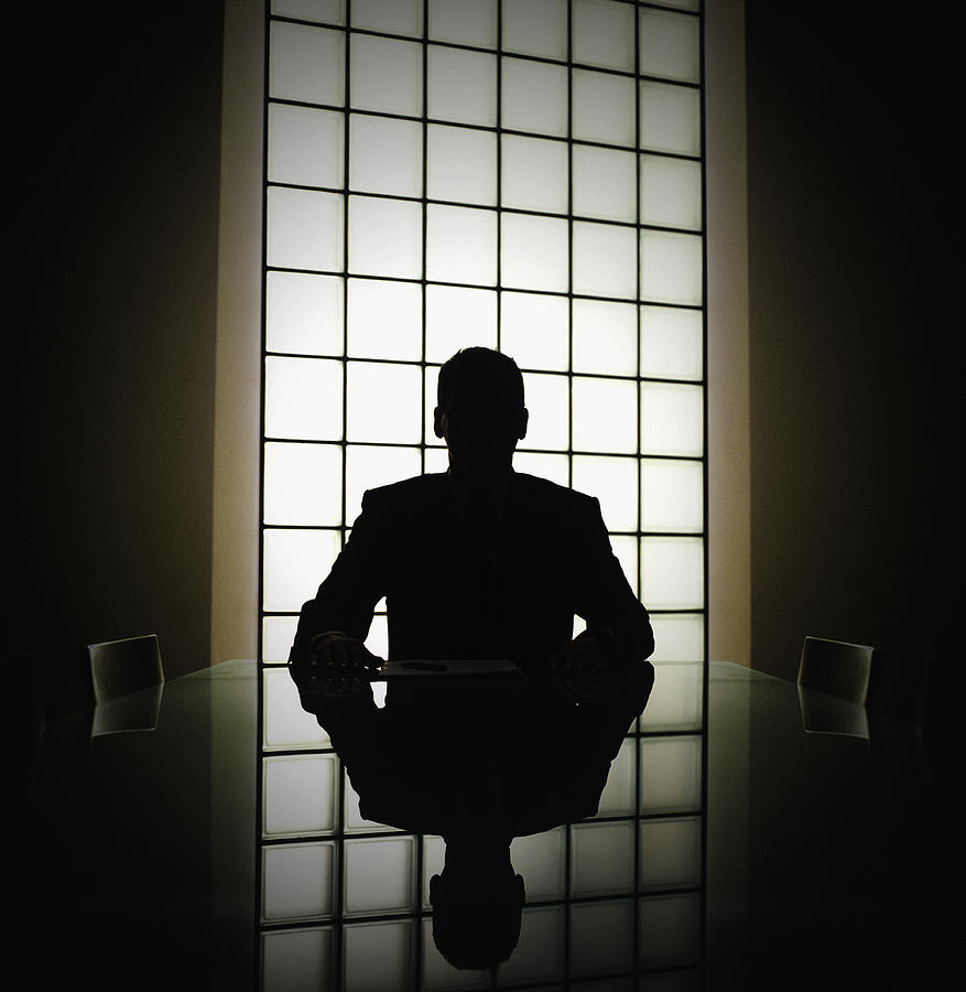 Business man or boss in silhouette interview Photograph by John Rensten
