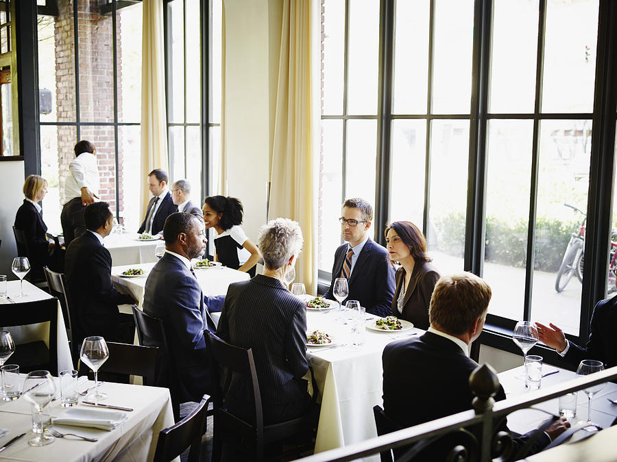 Business people having lunch in restaurant Photograph by Thomas Barwick