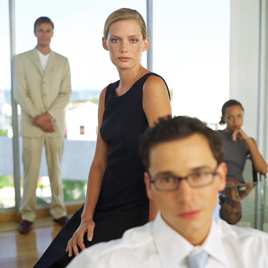 Business people in front of glass wall, portrait, blurred Photograph by Vincent Hazat