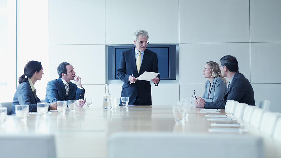 Business people in meeting in conference room Photograph by Martin Barraud