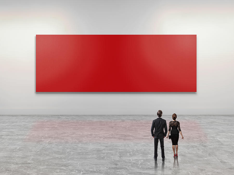 Business people looking at giant red art canvas Photograph by Paper Boat Creative