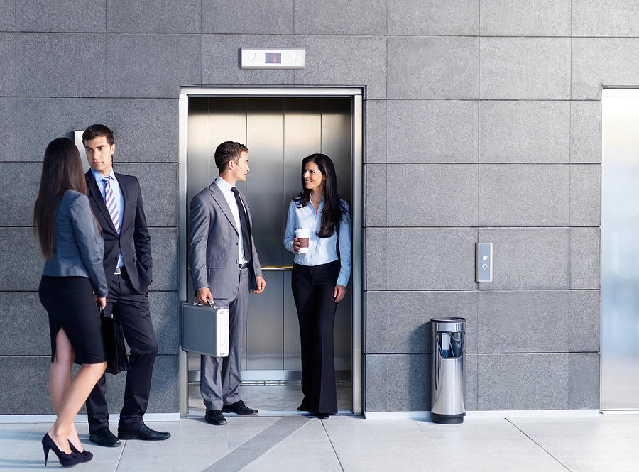Business people outside the elevator Photograph by Aldomurillo