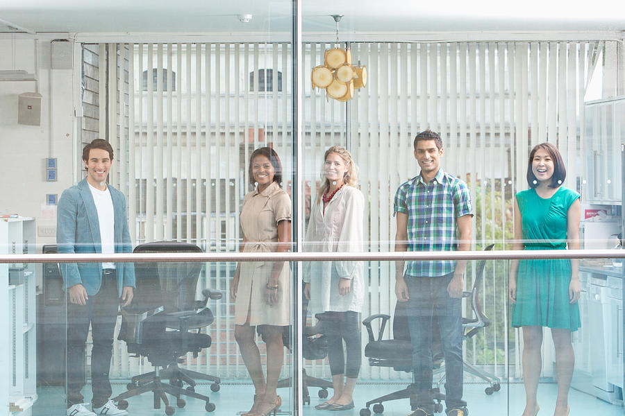 Business people standing at window  Photograph by Martin Barraud