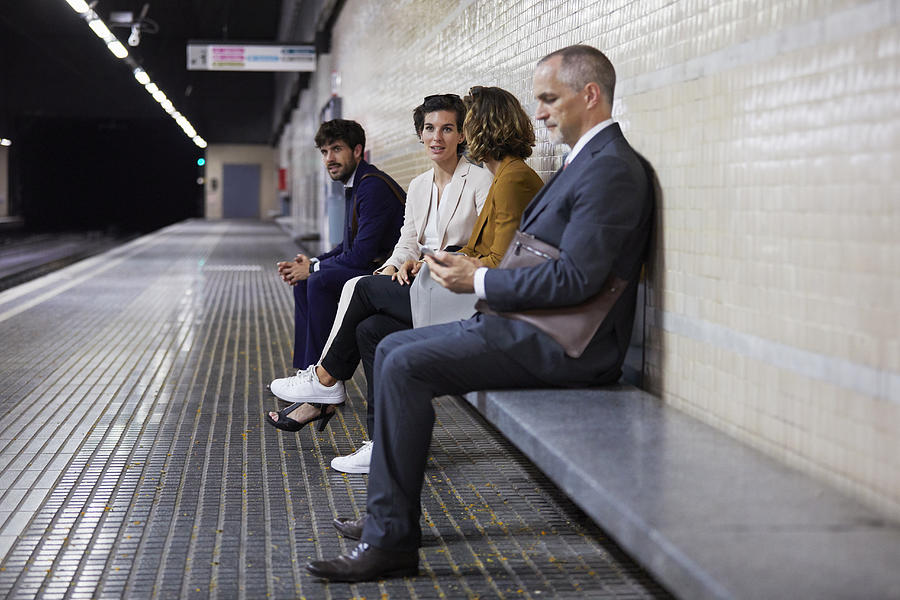 Business people waiting in subway station Photograph by Compassionate Eye Foundation/Morsa Images