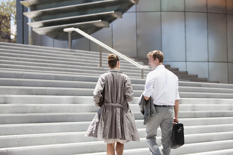Business people walking toward steps outdoors Photograph by Tom Merton