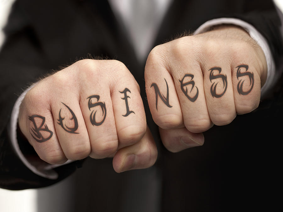 Business tattood on fists Photograph by Anthony Bradshaw