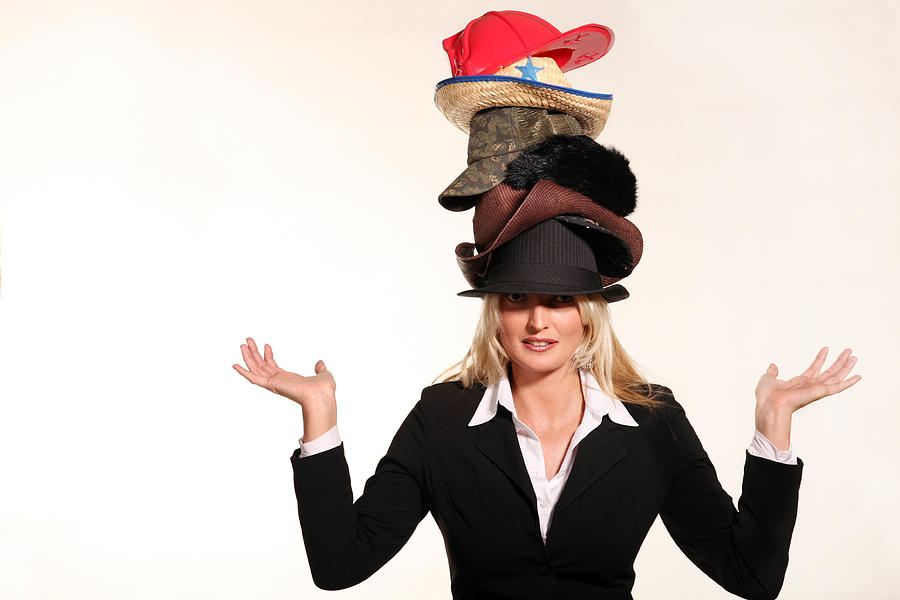 Business woman balancing life having to wear too many hats Photograph by ShaneKato