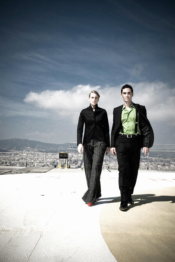 Businessman and Woman Walking off Helicopter Pad Photograph by Pixalot