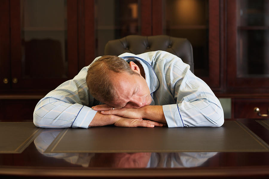 Businessman asleep at his desk Photograph by Image Source