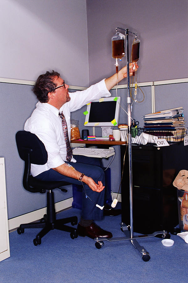 Businessman at messy desk with coffee IV Photograph by Thinkstock