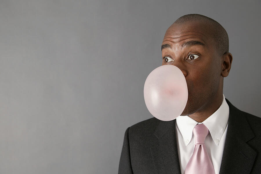 Businessman blowing bubble Photograph by Comstock Images