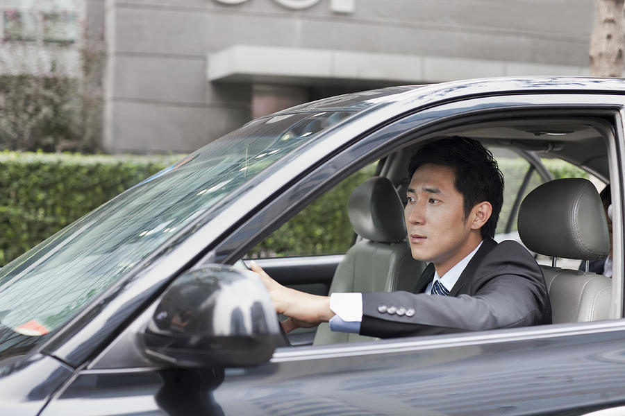 Businessman Driving Car Photograph by XiXinXing