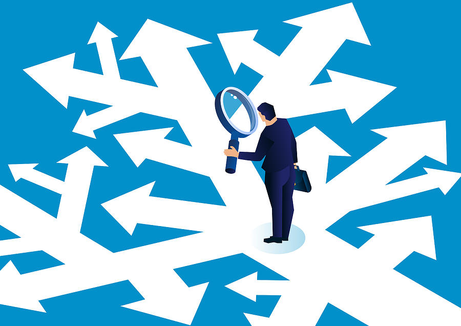 Businessman holding a magnifying glass standing in a complicated arrow path observing and making a choice Drawing by Sesame
