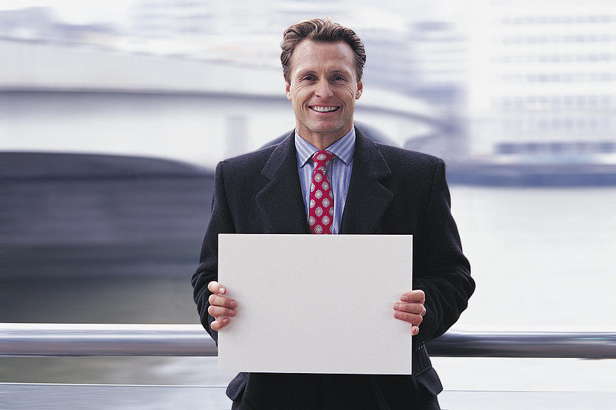 Businessman holding a piece of paper Photograph by Digital Vision.