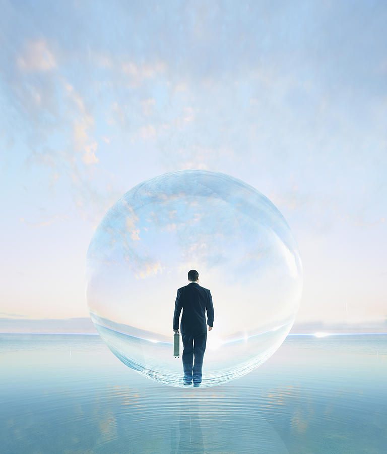 Businessman in bubble walking on water Photograph by Colin Anderson Productions pty ltd