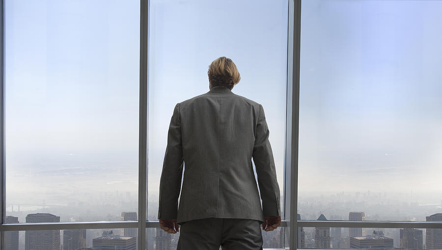 Businessman In His Office Overlooking A City Photograph by Buena Vista Images