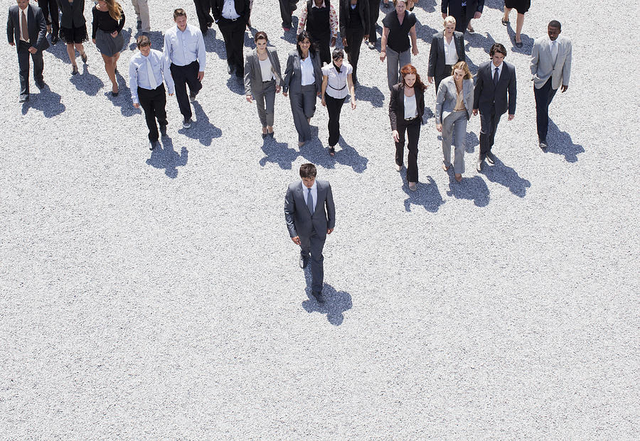 Businessman leading business people Photograph by Martin Barraud