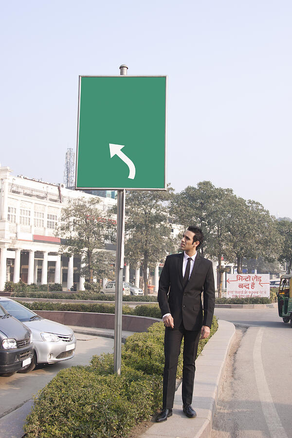 Businessman looking at something , INDIA , DELHI Photograph by IndiaPix/IndiaPicture
