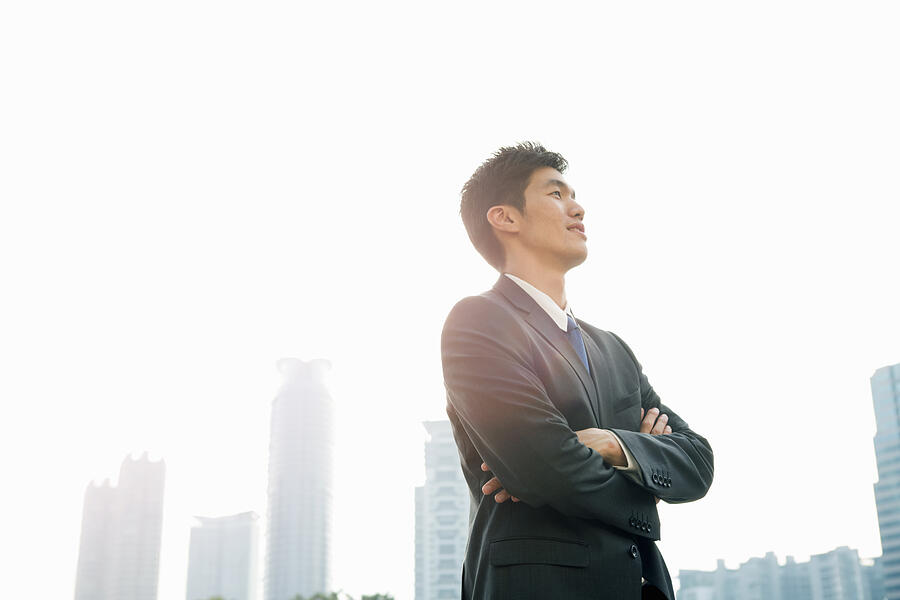 Businessman looking up with arms folded Photograph by Eternity in an Instant