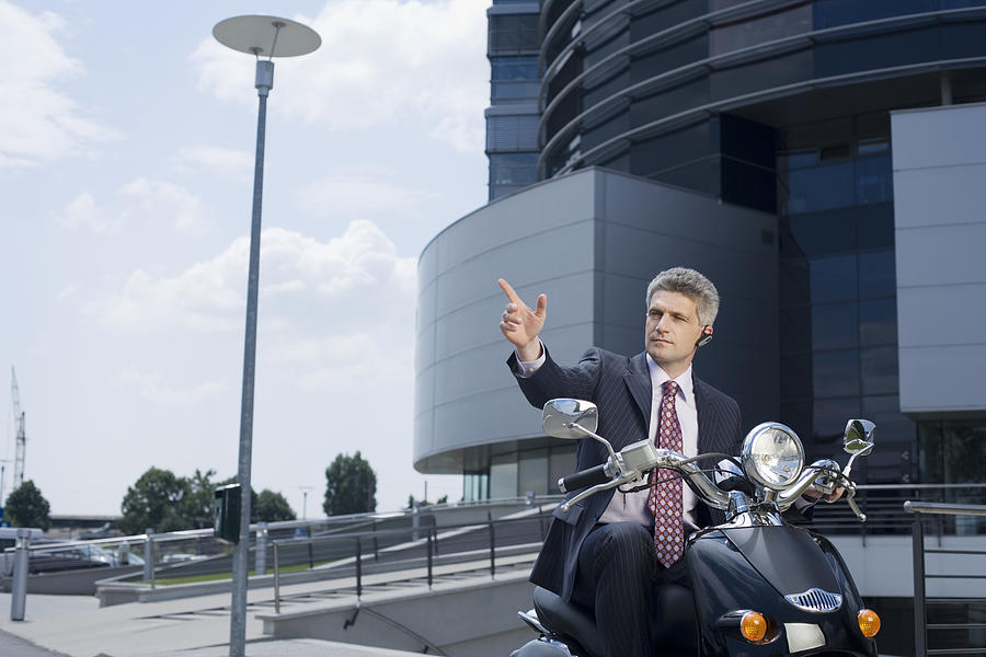 Businessman on motorcycle Photograph by Jupiterimages