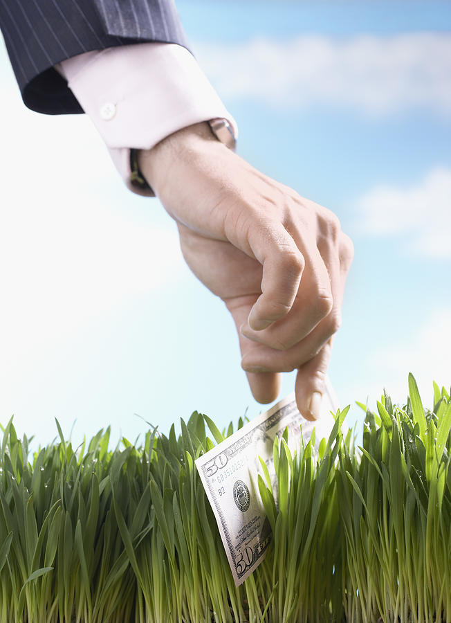 Businessman Picking Up 50-Dollar Bill From Grass Photograph by Moodboard